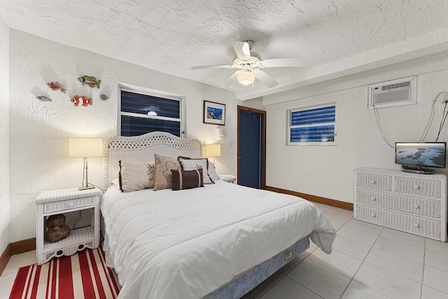 tiled bedroom with ceiling fan, a wall unit AC, and a textured ceiling