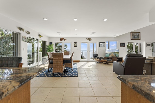 tiled dining space featuring french doors