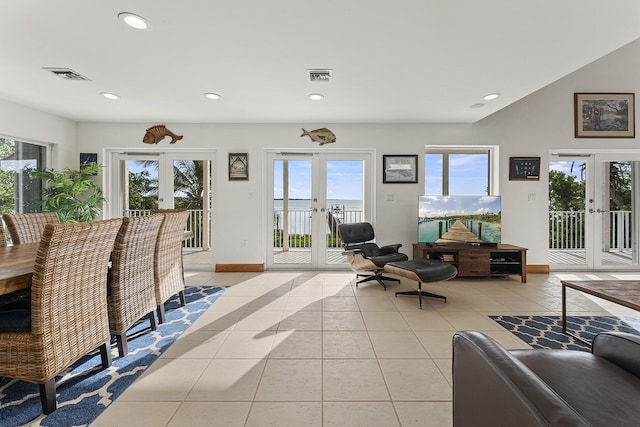 living room with french doors, plenty of natural light, and light tile patterned floors