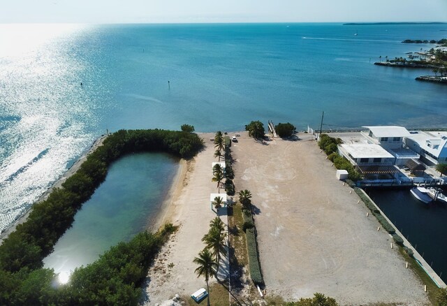 birds eye view of property featuring a view of the beach and a water view