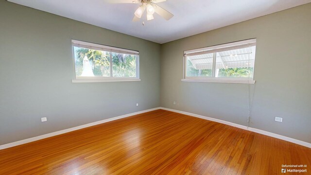 spare room featuring hardwood / wood-style floors, plenty of natural light, and ceiling fan