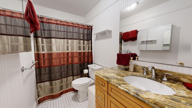 bathroom with walk in shower, tile patterned floors, vanity, and toilet