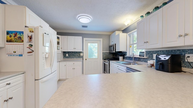 kitchen with stainless steel appliances, sink, and white cabinets