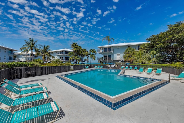 12690 Overseas Hwy Unit 411, Marathon, FL 33050 - community pool featuring a patio, fence, and a residential view