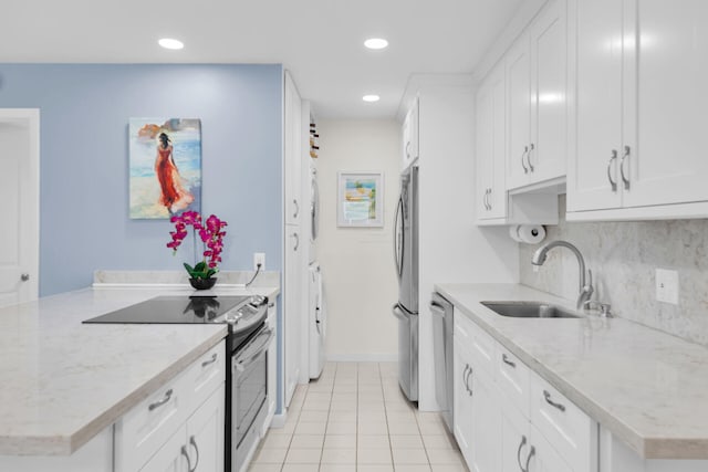 12690 Overseas Hwy Unit 411, Marathon, FL 33050 - kitchen with appliances with stainless steel finishes, a sink, white cabinets, recessed lighting, and light tile patterned flooring