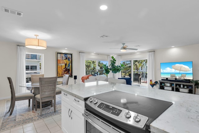 12690 Overseas Hwy Unit 411, Marathon, FL 33050 - kitchen with electric stove, open floor plan, ceiling fan, white cabinets, and light stone counters