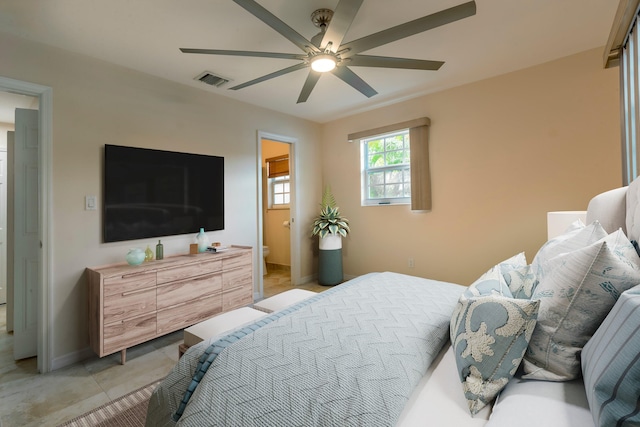 tiled bedroom featuring ensuite bathroom and ceiling fan