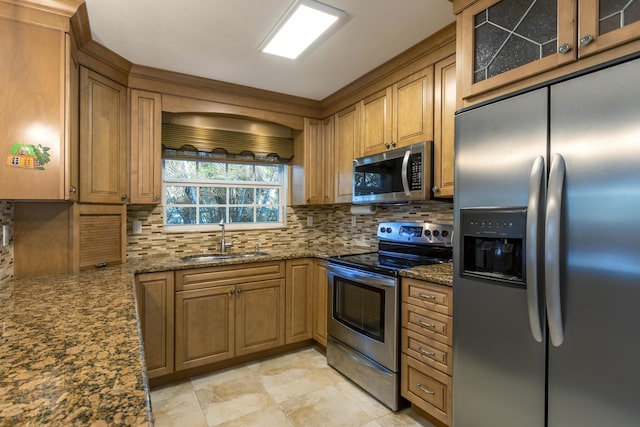 kitchen with sink, backsplash, dark stone counters, and appliances with stainless steel finishes