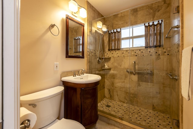 bathroom featuring walk in shower, vanity, and toilet