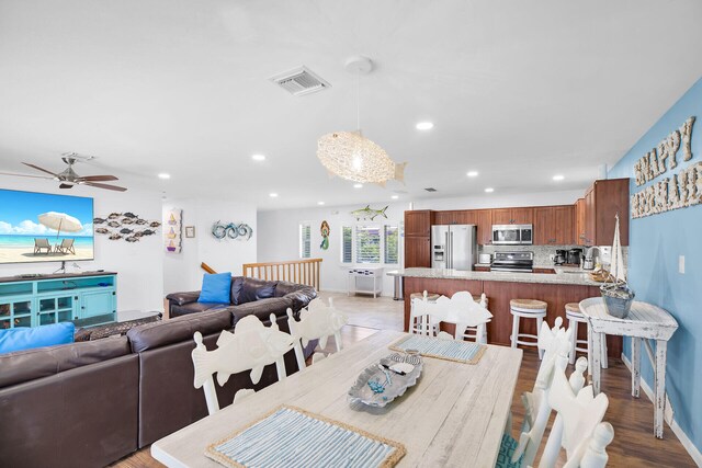 dining area with ceiling fan and light hardwood / wood-style flooring