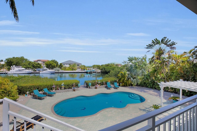 view of swimming pool featuring a water view, a patio area, and a pergola