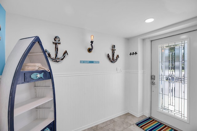 doorway to outside with light tile patterned floors and a wealth of natural light