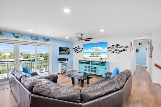 living room with ceiling fan and light wood-type flooring