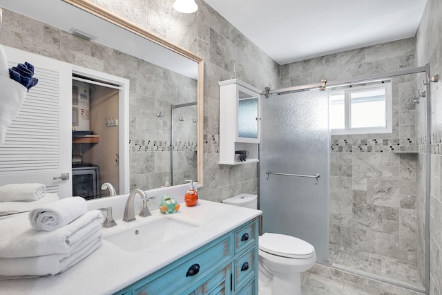 bathroom with tile walls, vanity, toilet, and walk in shower