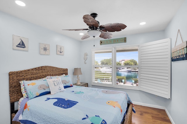 bedroom featuring wood-type flooring and ceiling fan