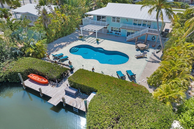 view of swimming pool with a water view, a pergola, a patio, and a boat dock