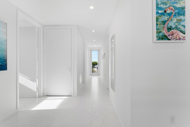 corridor with light tile patterned floors