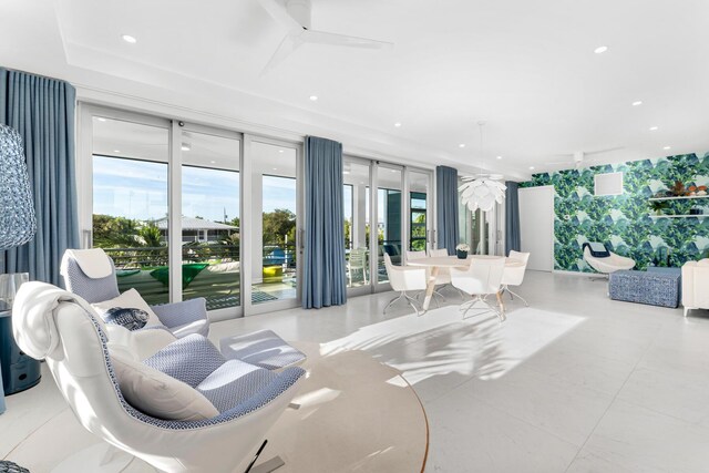 living room featuring ceiling fan and plenty of natural light