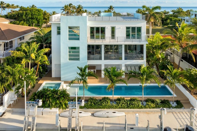 view of pool featuring a boat dock and a water view