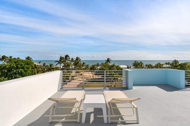 view of patio / terrace with a water view and a balcony