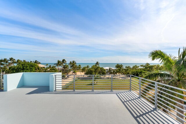 view of patio featuring a water view and a balcony