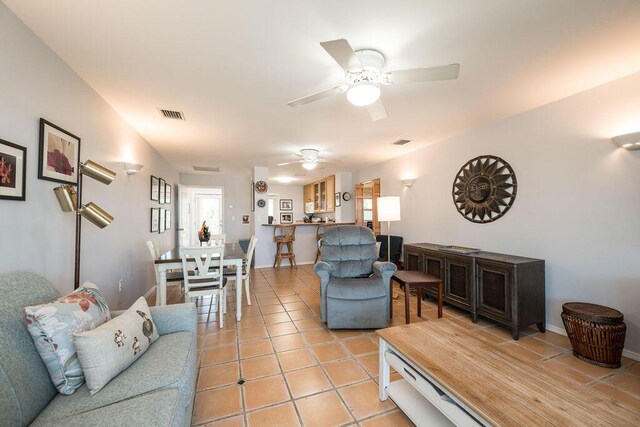 living room featuring light tile patterned flooring and ceiling fan