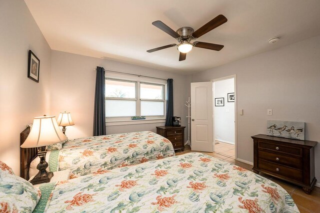 tiled bedroom with ceiling fan