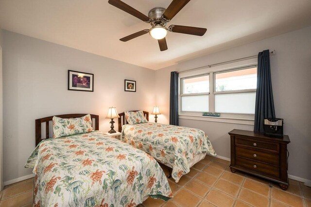 tiled bedroom with ceiling fan