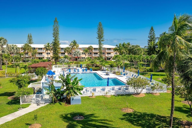 view of swimming pool featuring a yard and a patio