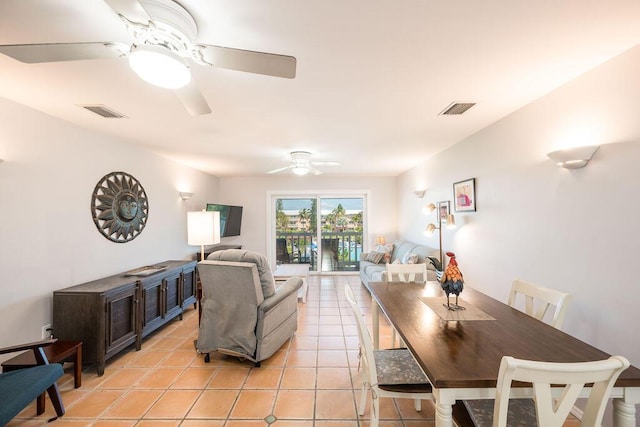 tiled dining room with ceiling fan