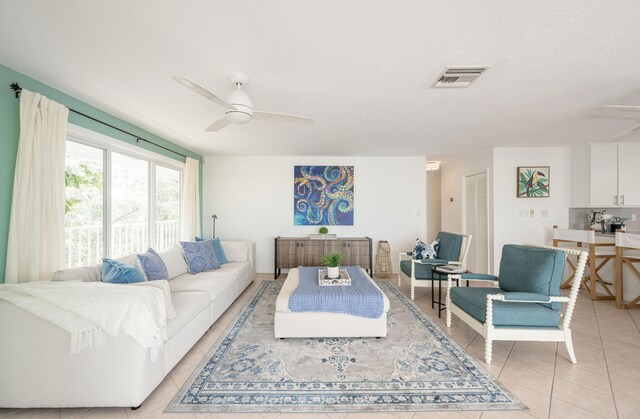 tiled living room with ceiling fan