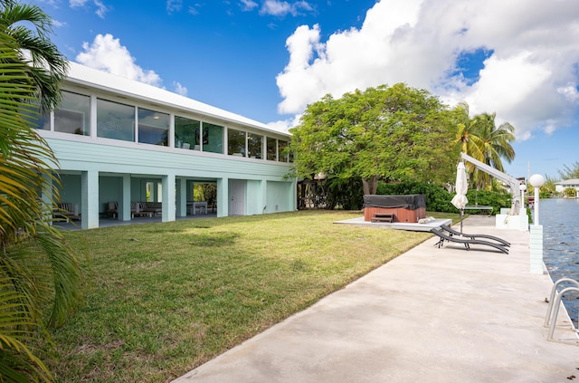 view of yard with a patio area and a hot tub