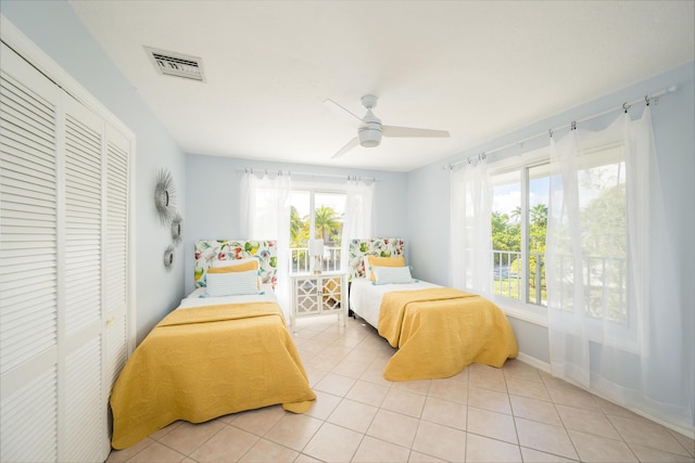 tiled bedroom featuring a closet and ceiling fan