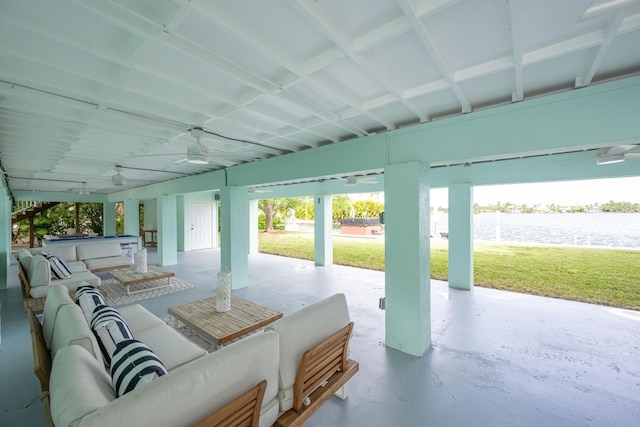 view of patio / terrace with an outdoor living space, a water view, and ceiling fan