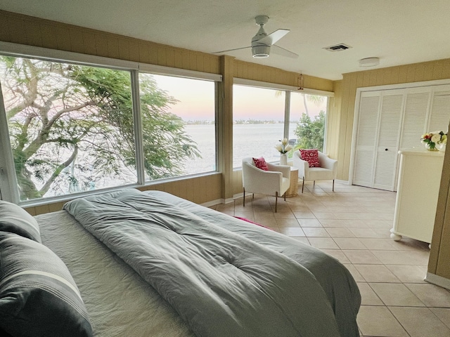 tiled bedroom with a water view