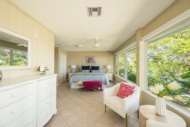 tiled bedroom featuring multiple windows