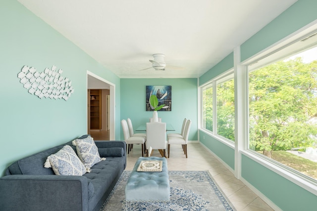 sunroom / solarium featuring ceiling fan