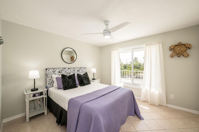 tiled bedroom featuring ceiling fan