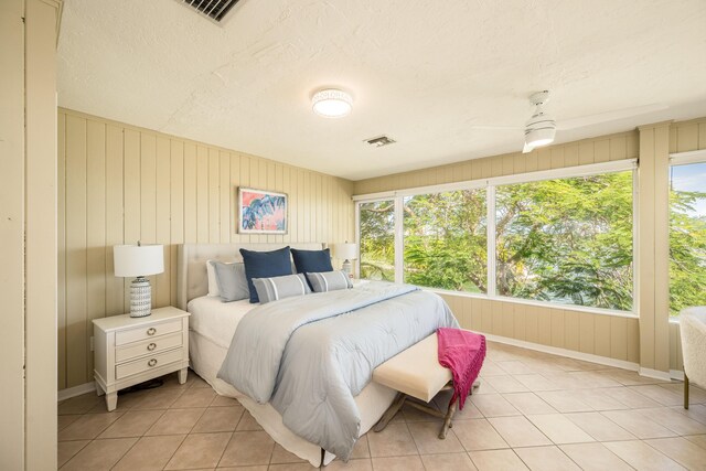 tiled bedroom with a textured ceiling