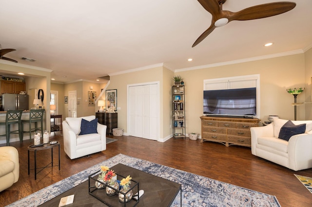 living room with dark wood-type flooring, ceiling fan, and ornamental molding