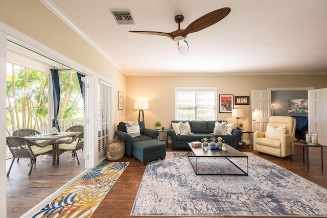 living room with dark hardwood / wood-style flooring, ornamental molding, and ceiling fan