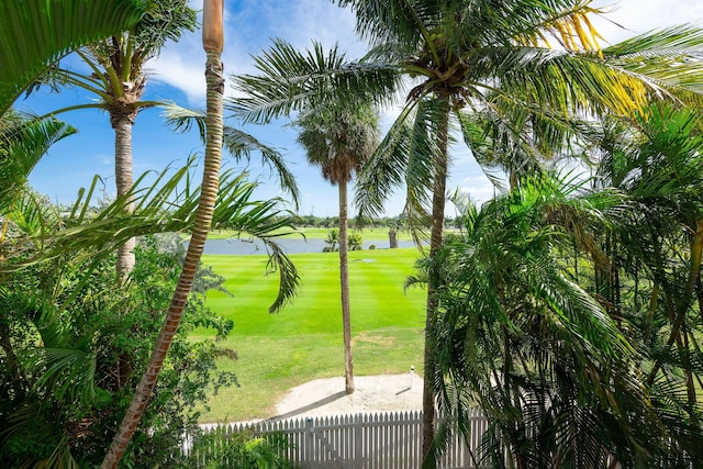 view of home's community with a water view and a yard