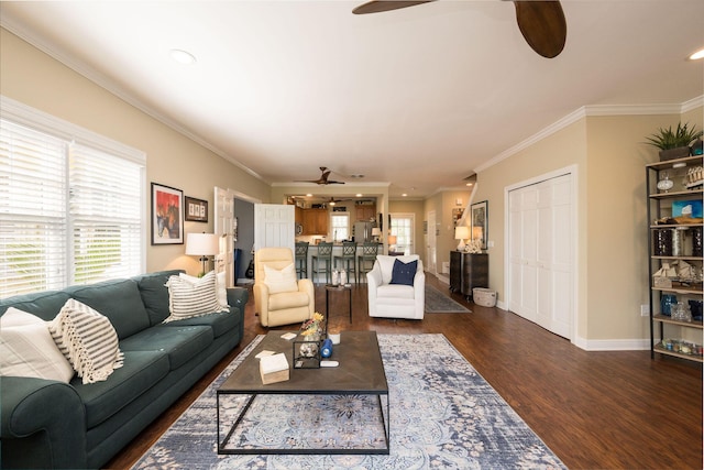 living room featuring dark hardwood / wood-style flooring, ornamental molding, a healthy amount of sunlight, and ceiling fan