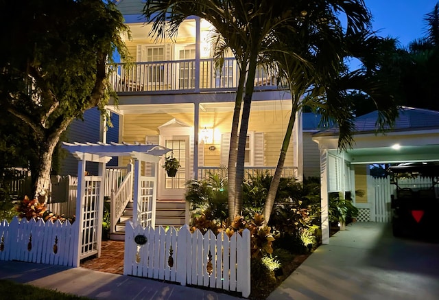 view of front of home with a balcony and a pergola