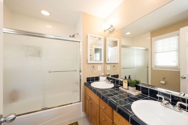 bathroom featuring vanity and shower / bath combination with glass door