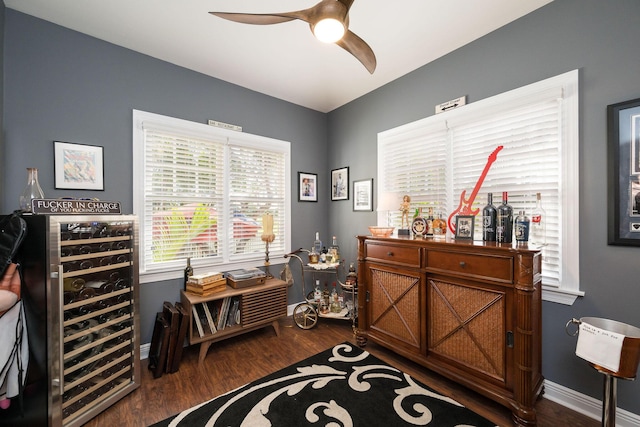 interior space featuring ceiling fan, beverage cooler, and dark hardwood / wood-style floors