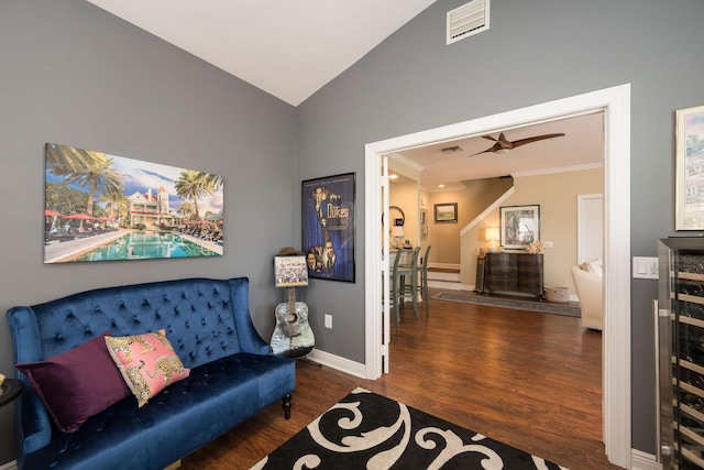 living area featuring wine cooler, crown molding, lofted ceiling, and dark hardwood / wood-style floors