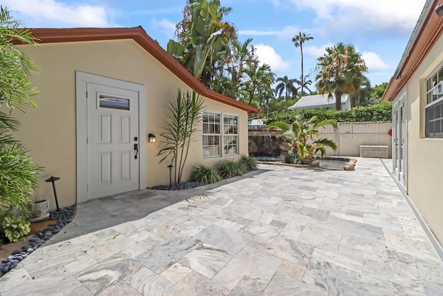 215 Whitehead St, Key West, FL 33040 - view of exterior entry featuring stucco siding and a patio