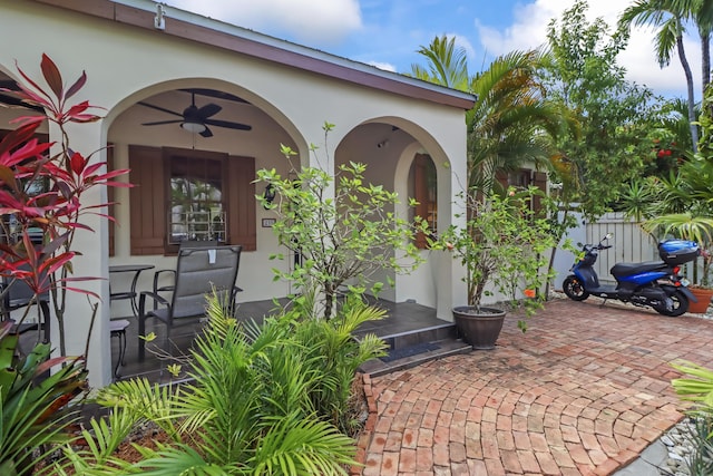 215 Whitehead St, Key West, FL 33040 - view of exterior entry with stucco siding and ceiling fan