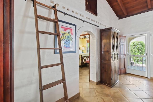 215 Whitehead St, Key West, FL 33040 - foyer entrance with a wooden ceiling with exposed beams, light tile patterned floors, high vaulted ceiling, arched walkways, and a barn door
